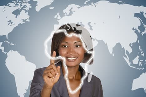 A recruiter in front of a world map, the African continent picked out in light beside her.